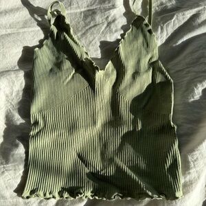 Green sleeveless camisole with ribbed texture and scoop neck